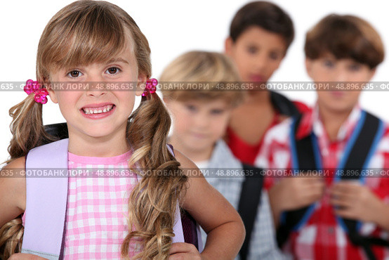 schoolgirl with satchel and boys in background. Стоковое фото, агентство Ingram Publishing / Фотобанк Лори