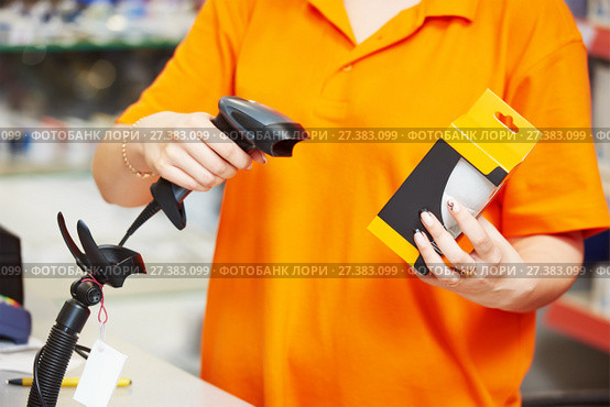 Seller with barcode scanner in shop. Стоковое фото, фотограф Дмитрий Калиновский / Фотобанк Лори