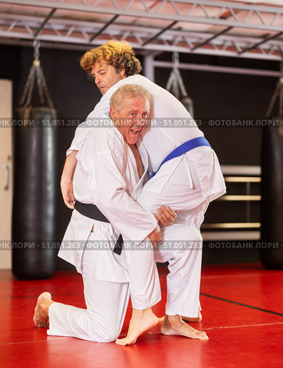 Senior aikido practitioner training with partner in dojo. Стоковое фото, фотограф Яков Филимонов / Фотобанк Лори
