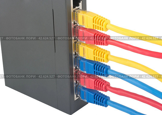 Сетевой коммутатор с подключенными разноцветными сетевыми кабелями. Closeup of network cables connected to router on white. Стоковое фото, фотограф Татьяна Д / Фотобанк Лори
