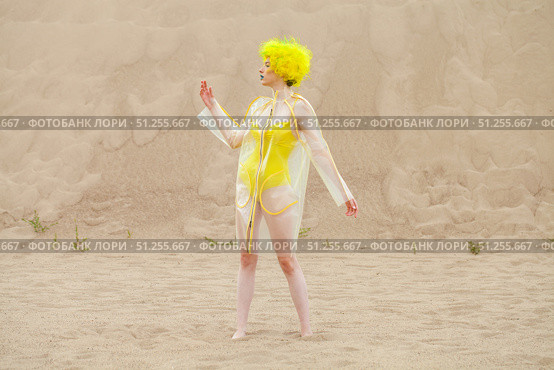 Sexy beautiful woman in a bright yellow wig and transparent raincoat. Стоковое фото, фотограф Андрей Аркуша / Фотобанк Лори