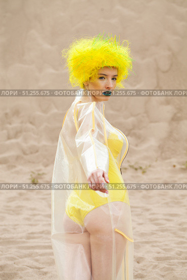 Sexy beautiful woman in a bright yellow wig and transparent raincoat. Стоковое фото, фотограф Андрей Аркуша / Фотобанк Лори