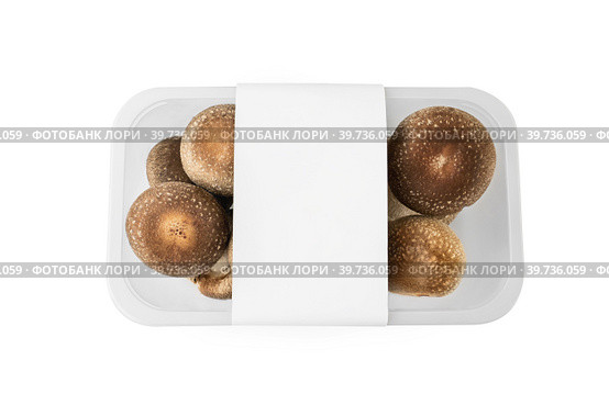 shiitake organic mushrooms for sale in a plastic tray on a light background. lentinula edible, Japanese forest mushroom. Стоковое фото, фотограф Оксана Медведева / Фотобанк Лори
