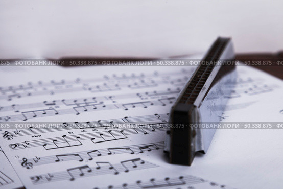 shiny harmonica sheet music. Стоковое фото, агентство Ingram Publishing / Фотобанк Лори