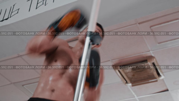 Shirtless sweaty young man training boxing in the gym. Стоковое видео, видеограф Константин Шишкин / Фотобанк Лори
