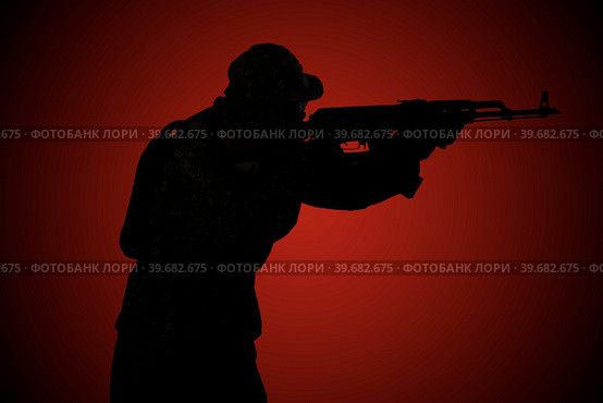 Silhouette of a military man with a rifle at night on a red background. Side view. Стоковое фото, фотограф Владимир Арсентьев / Фотобанк Лори