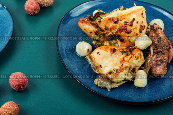 Slice of baked chicken meat with lychee on a plate.. Plate of chicken roasted with lychee. Стоковое фото, агентство Ingram Publishing / Фотобанк Лори