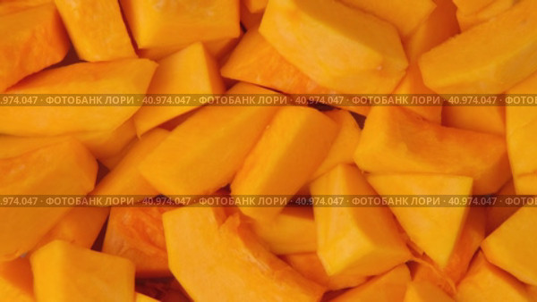 Slices of fresh pumpkin chunks background. Yellow Juicy pieces of pumpkin. Texture close up. Turning, rotation. Full frame with copy space for text, label. Food backdrop. Bright orange sliced pumpkin. Стоковое видео, видеограф Марина Демидюк / Фотобанк Лори