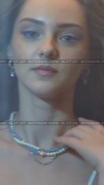 Slow motion vertical video of young female covered with veil. Woman is dressed in a peignoir and wears a necklace and earrings. Стоковое видео, видеограф Сергей Пристяжнюк (Serg Zastavkin) / Фотобанк Лори