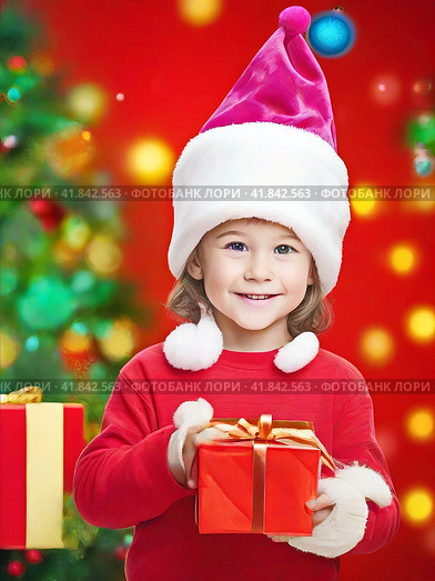 Smiling boy in a red Christmas hat with gifts near the Christmas tree. Стоковое AI-изображение, AI-художник Сергей Елизарьев / Фотобанк Лори