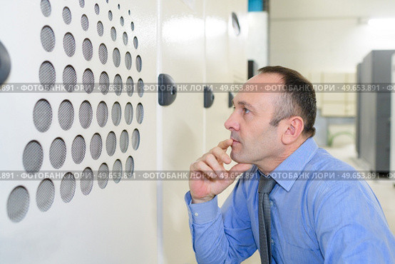smiling professional checking finishing at factory. Стоковое фото, агентство Ingram Publishing / Фотобанк Лори