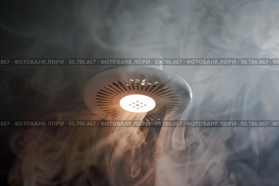 Smoke detector sensing smoke and triggering alarm system in home. Стоковое AI-изображение, AI-художник Иван Рябоконь / Фотобанк Лори