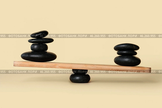 Spa stones on teeterboard against light background. Concept of balance. Стоковое фото, фотограф Pixel_shot / Фотобанк Лори