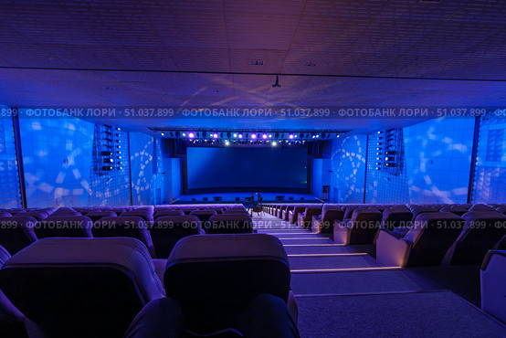Spacious auditorium with blue lighting and theater setup. Стоковое фото, фотограф Антон Гвоздиков / Фотобанк Лори