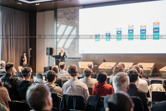 Speaker giving a talk in conference hall at business event. Rear view of unrecognizable people in audience at the conference hall. Business and entrepreneurship concept. Стоковое фото, фотограф Matej Kastelic / Фотобанк Лори