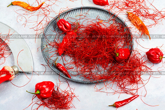 Spicy seasoning, spice, cut from red pepper. Thinly sliced pepper.. Cutting red chilly peppers. Стоковое фото, агентство Ingram Publishing / Фотобанк Лори