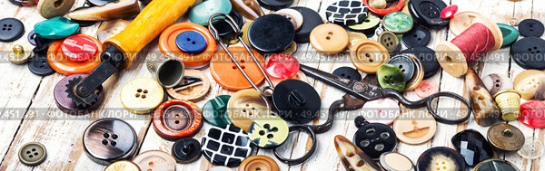 Spools of threads and buttons on wooden table.Scissor, sewing buttons and thread. Sewing tools and accessories. Стоковое фото, агентство Ingram Publishing / Фотобанк Лори