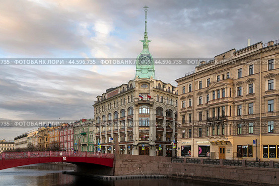 St. Petersburg, Russia, 04.30.2023: View of the historical building of the store "At the Red Bridge" of the Belgian-Dutch trading company "S.Esders and K.Scheifals" on the Moika River embankment. Редакционное фото, фотограф Ula Ulachka / Фотобанк Лори