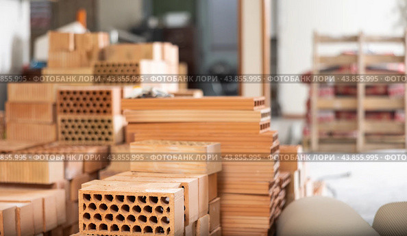 Stack of red bricks inside building under construction. Стоковое фото, фотограф Яков Филимонов / Фотобанк Лори