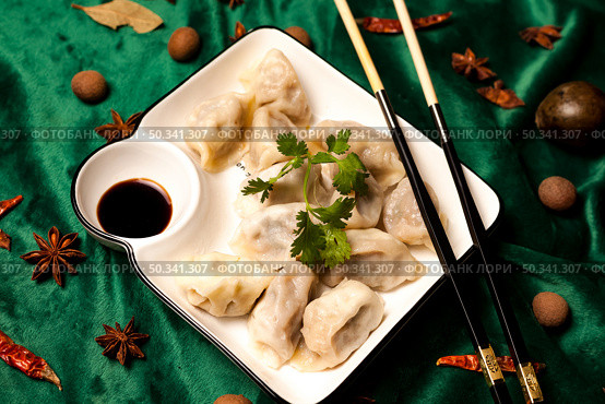 Steaming Chinese Dumplings With Soy Sauce Presented Beautifully on a Table. Стоковое фото, фотограф Aleksandr Golubev / Фотобанк Лори