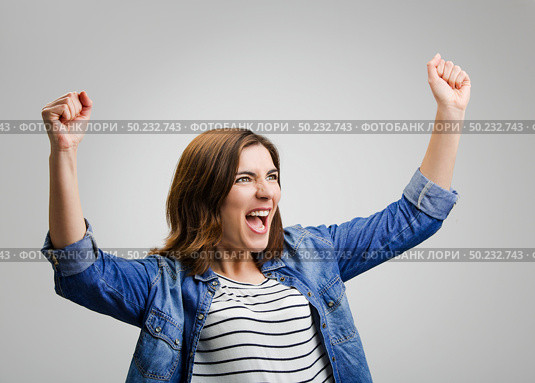 Studio portrait of a successful woman with arms raised. Стоковое фото, агентство Ingram Publishing / Фотобанк Лори