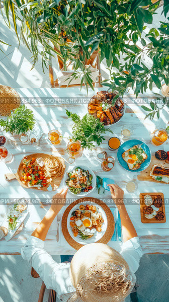 Sun-Drenched Brunch: Overhead View of Person at Table Laden with Food, Plants, and Refreshments for a Delicious Summer Feast. Стоковое AI-изображение, AI-художник Данила Большаков / Фотобанк Лори