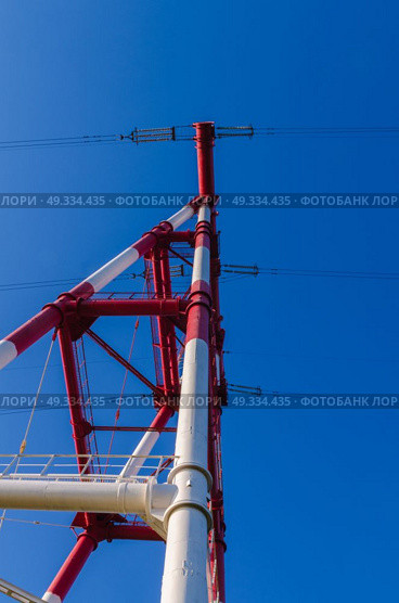 supports of high-voltage power lines against the blue sky. Стоковое фото, агентство Ingram Publishing / Фотобанк Лори