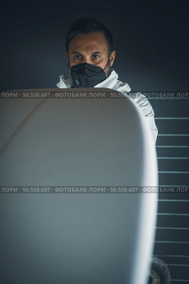 Surfboard manufacturing, Shaper working on board details. Concept of industrial manufacturing, qualified professional, occupation and employment. Стоковое фото, агентство Ingram Publishing / Фотобанк Лори