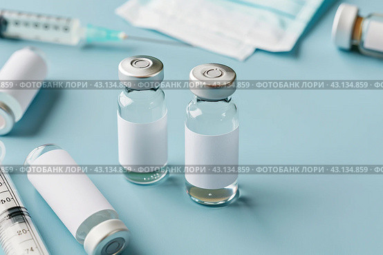 Syringe and glass vial on blue background table. Medical Vials group, needles, ampoules, bottle with medicines or vaccine. Disease treatment. Creative Banner. Anti-aging beauty injections. Vaccination. Стоковое AI-изображение, AI-художник Марина Демидюк / Фотобанк Лори