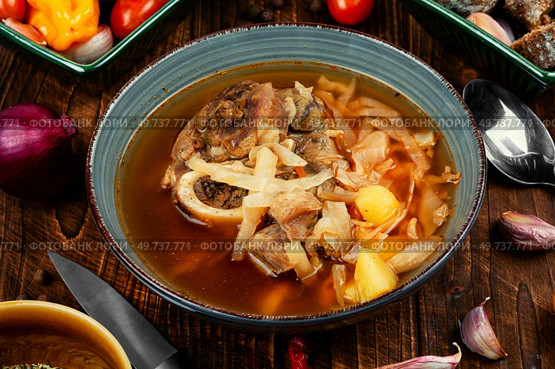 Tasty soup with meat on the table. Traditional Ukrainian Russian borshch.. Traditional soup borscht in bowl. Стоковое фото, агентство Ingram Publishing / Фотобанк Лори