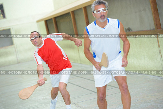 team of men playing basque squash. Стоковое фото, агентство Ingram Publishing / Фотобанк Лори