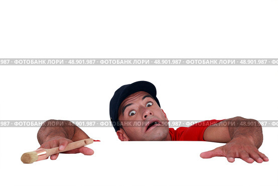 Terror-stricken man holding on for dear life. Стоковое фото, агентство Ingram Publishing / Фотобанк Лори