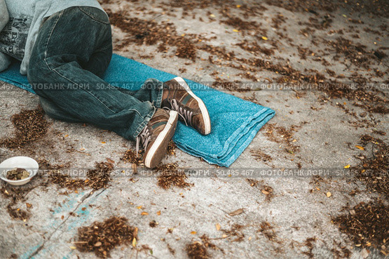 The beggars lay on their side of the street with dirty clothes. Стоковое фото, агентство Ingram Publishing / Фотобанк Лори