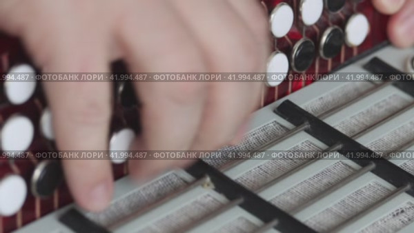 The man checks the condition of the button accordion. Evaluates the compression of the valves. Bayan repair and maintenance. Close-up. Стоковое видео, видеограф Vadzim Yakubovich / Фотобанк Лори