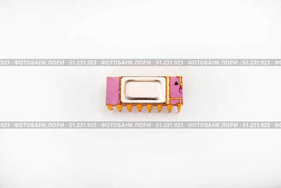 The microcircuit. An old microcircuit on a white background. An electronic device. Стоковое фото, фотограф Valeriy Lushchikov / Фотобанк Лори
