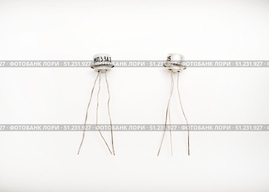 The microcircuit. An old microcircuit on a white background. An electronic device. Стоковое фото, фотограф Valeriy Lushchikov / Фотобанк Лори