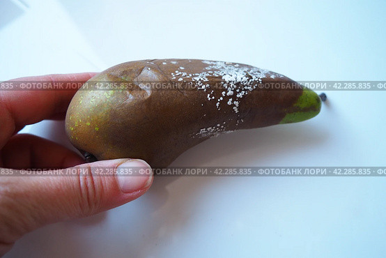 The pear became moldy. A mold or mould. The dust-like, colored appearance of molds is due to the formation of spores containing fungal secondary metabolites. Perishable food products. White background. Стоковое фото, фотограф Юлия Петровская / Фотобанк Лори