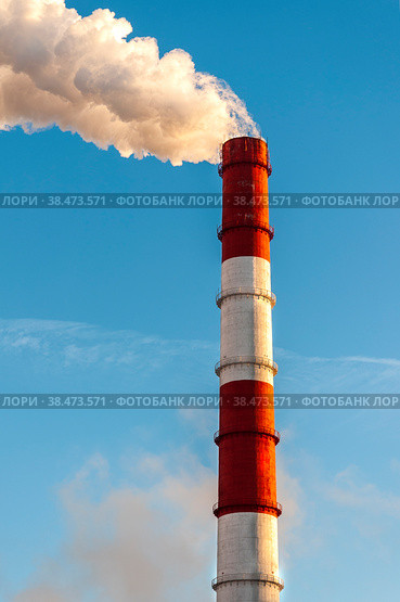 The pipe of the thermal power plant on the background of the blue sky. The concept of ecology and environmental protection. Стоковое фото, фотограф Ярославский Максим / Фотобанк Лори