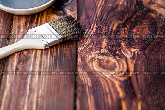 The procedure for protecting and coating wooden boards. The texture of wood treated with stain. Close-up of stain and brush. Стоковое фото, фотограф Photojuli / Фотобанк Лори