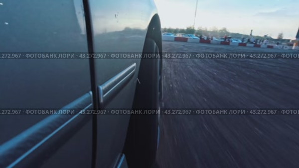 The work of the front wheel of the drift car during the arrival at the site at sunset. Close-up. Стоковое видео, видеограф Ярославский Максим / Фотобанк Лори