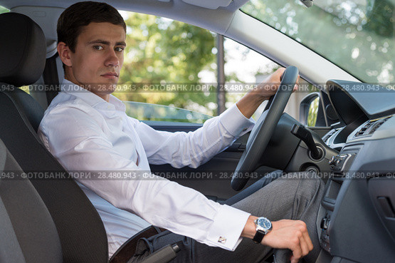 The young man behind the wheel driving car. Стоковое фото, фотограф Kirill Kedrinskiy / Ingram Publishing / Фотобанк Лори