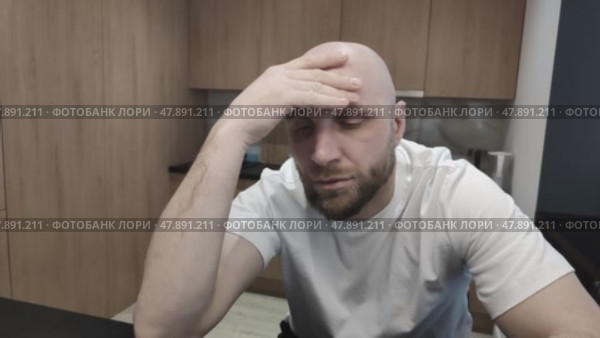 Thoughtful bald man rubs his head with his hand. Bearded guy thinking about solving problems. Sad young man focused on difficulties and ways out of them. Стоковое видео, видеограф Ирина / Фотобанк Лори