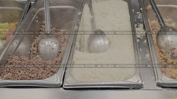 Three trays with food and cutlery. The trays are filled with rice, buckwheat porridge and other products. close-up. Стоковое видео, видеограф Скрипачев Антон / Фотобанк Лори