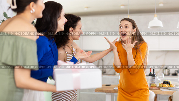Three women have arrived for birthday celebration and presenting gift to birthday woman. Стоковое фото, фотограф Яков Филимонов / Фотобанк Лори