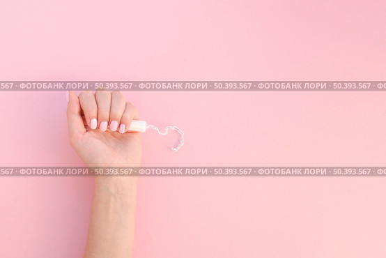 top view hand holding tampon pink background. Стоковое фото, агентство Ingram Publishing / Фотобанк Лори