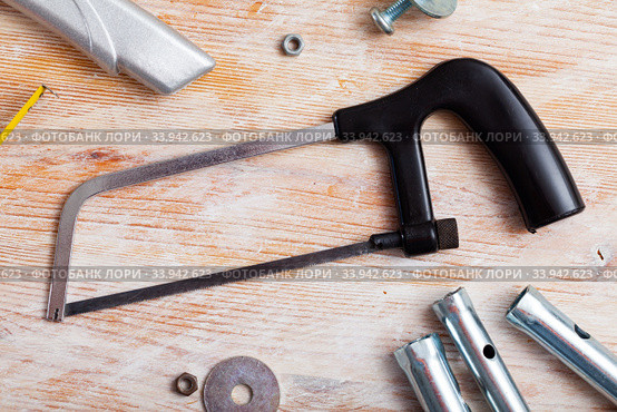 Top view of hacksaw surrounded by various tools. Стоковое фото, фотограф Яков Филимонов / Фотобанк Лори