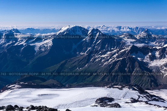 Top view of the high mountains above the clouds from the slope of Mount Elbrus. Стоковое фото, фотограф Евгений Харитонов / Фотобанк Лори