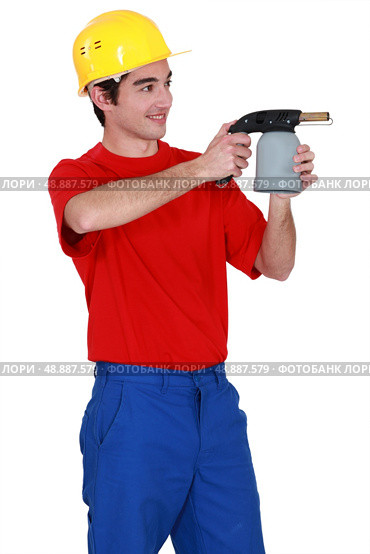 Tradesman holding a blowtorch. Стоковое фото, агентство Ingram Publishing / Фотобанк Лори