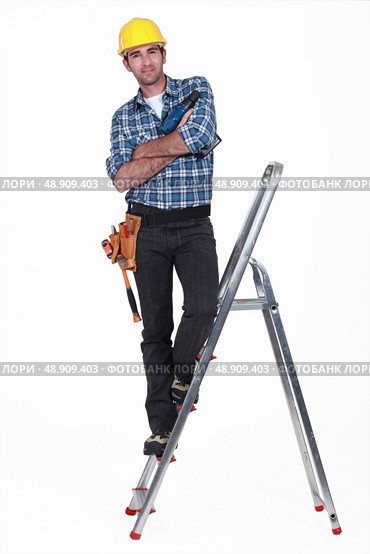 Tradesman standing on a stepladder. Стоковое фото, агентство Ingram Publishing / Фотобанк Лори