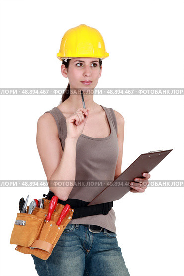 Tradeswoman completing an evaluation. Стоковое фото, агентство Ingram Publishing / Фотобанк Лори